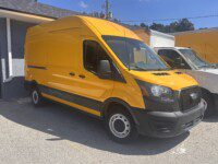 A yellow van parked in a parking lot.
