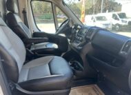 Interior view of a modern cargo van, showing driver and passenger seats and dashboard.
