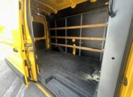 Interior of a yellow cargo van with wooden shelving and a black floor.