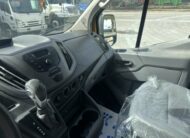 Interior view of a modern van dashboard, showing gear shift and driver's seat.