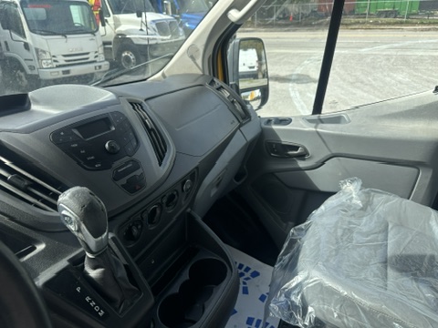 Interior view of a modern van dashboard, showing gear shift and driver's seat.