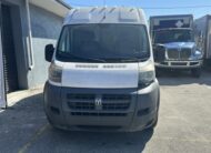 White Ram ProMaster van parked outdoors with a blue truck in the background.