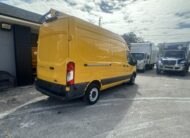 Bright yellow Ford Transit van parked outdoors, ready for delivery services.