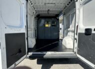 Interior view of a white cargo van with rear doors open.
