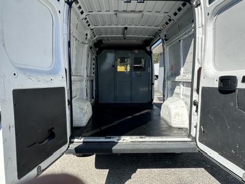 Interior view of a white cargo van with rear doors open.