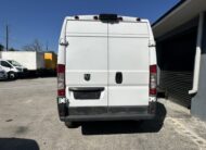 Rear view of a white Ram ProMaster van parked outdoors