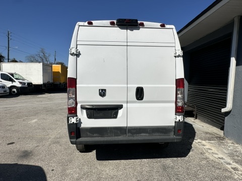 Rear view of a white Ram ProMaster van parked outdoors