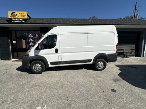 White Ram ProMaster van parked outside box trucks rental business