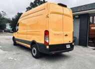 Yellow Ford Transit van parked on asphalt