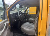 Interior view of a 2020 GMC Savana 3500 box truck, showing driver and passenger seats.