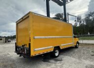 Yellow 2020 GMC Savana 3500 box truck parked in a lot