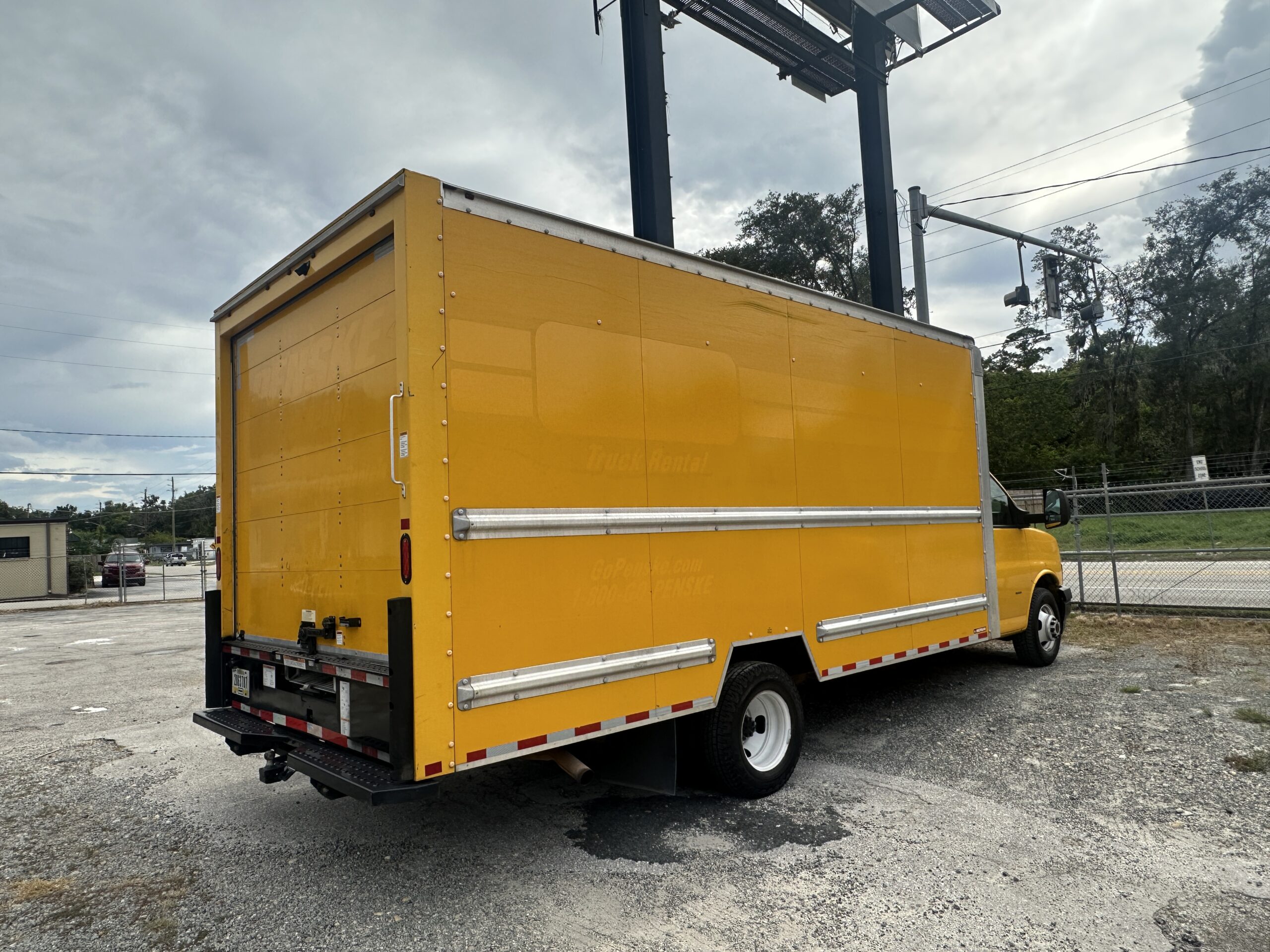 Yellow 2020 GMC Savana 3500 box truck parked in a lot