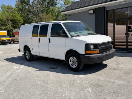 2009 white Chevy G2500 cargo van parked outside a U-Haul location.