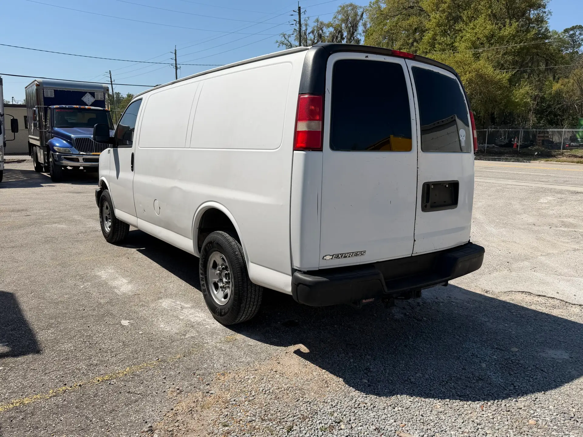 Rear view of a white 2009 Chevy G2500 cargo van parked outdoors.