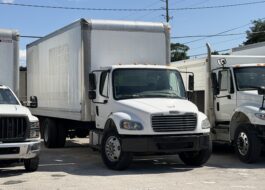 White Freightliner box truck with "Sight & Sound" logo parked outdoors.