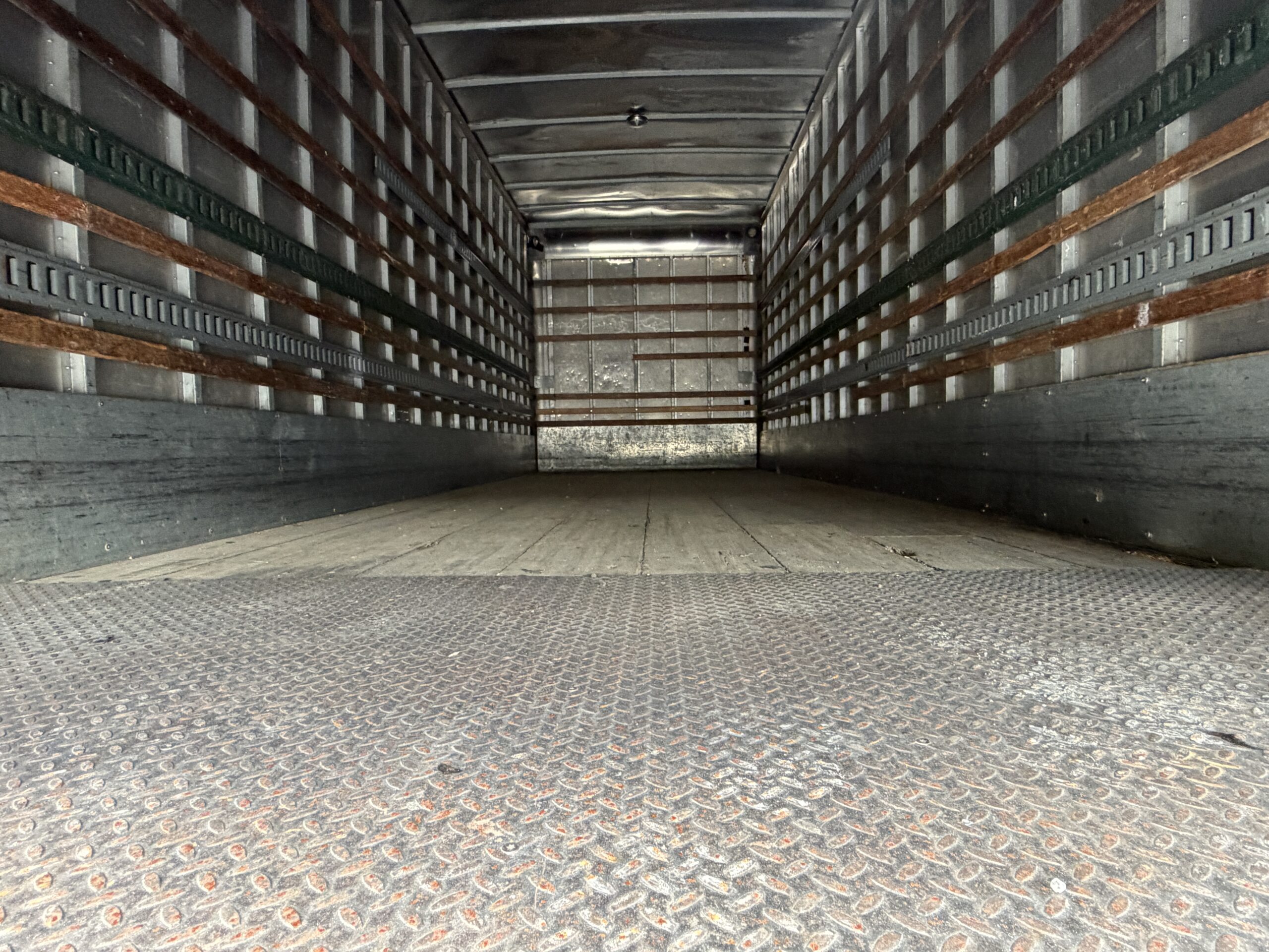 Interior of a 2007 Freightliner M2 box truck, showing the empty cargo area.