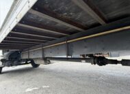 2007 Freightliner M2 box truck undercarriage with driveshaft and liftgate components.
