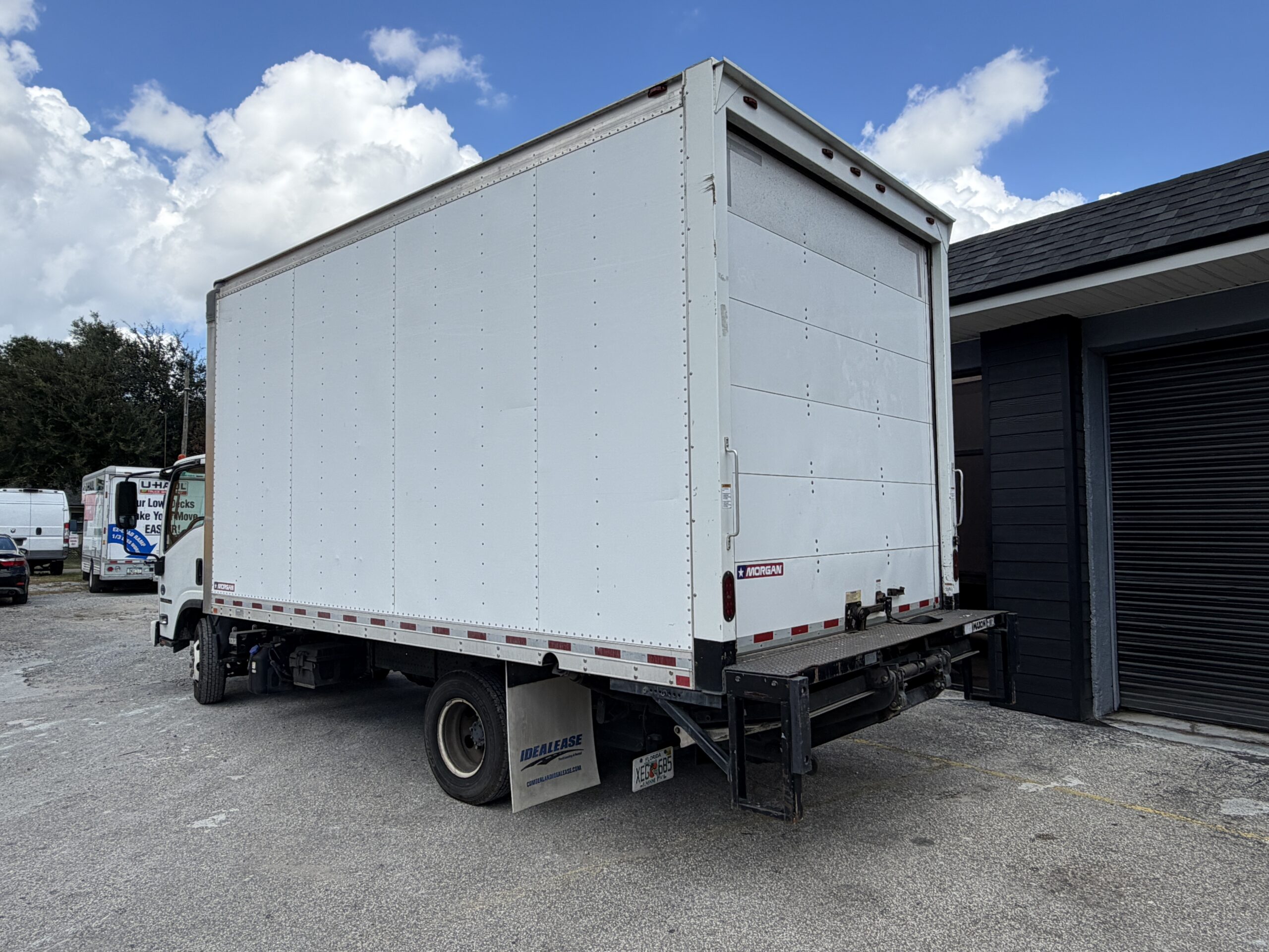 2019 Isuzu NQR 16ft. diesel box truck with liftgate, parked outside.