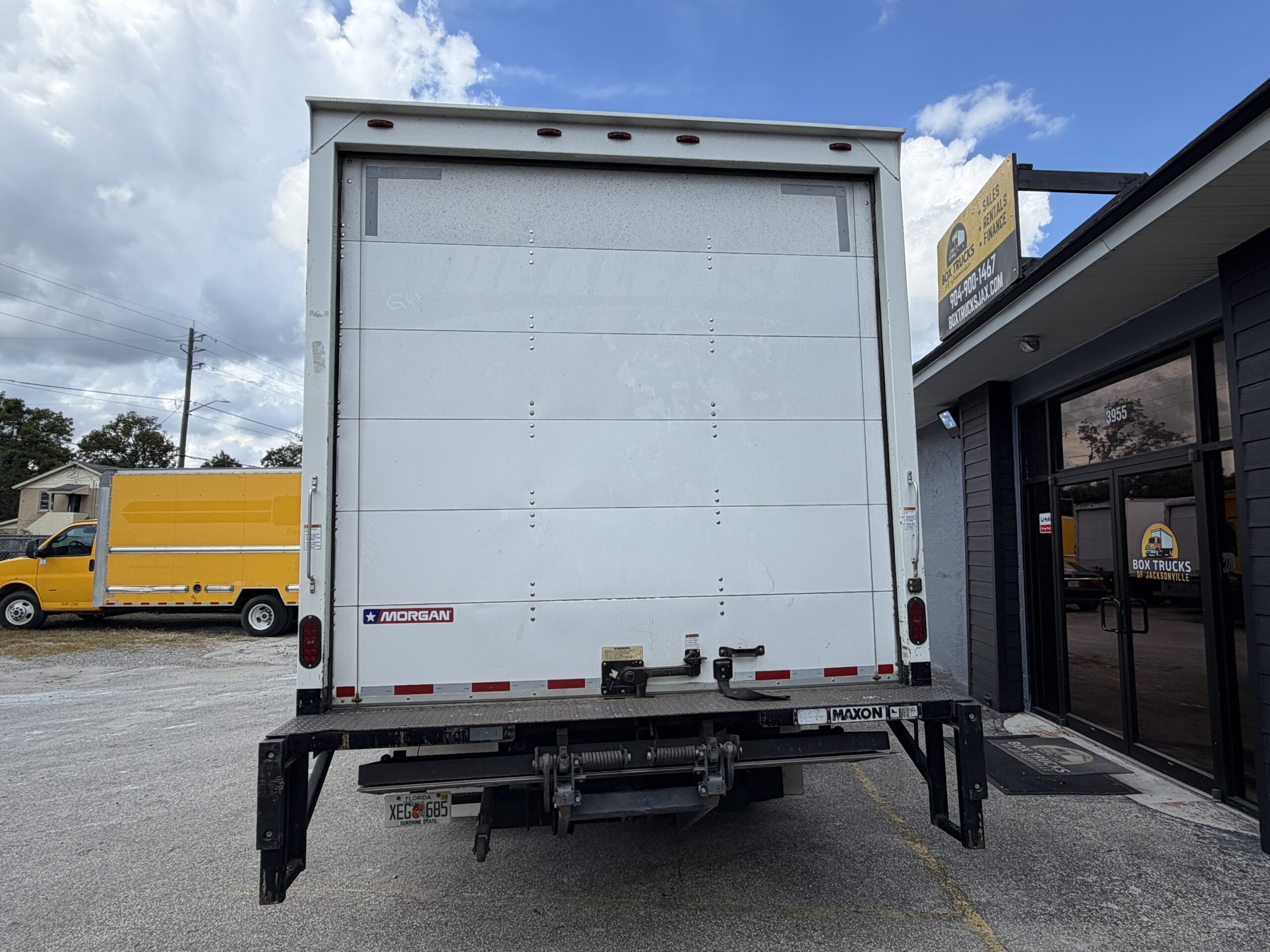 Rear view of a 2019 Isuzu NQR 16ft. diesel box truck with liftgate.