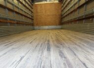 Interior of a clean, empty 16ft Isuzu NQR diesel box truck cargo area.