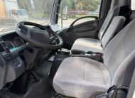Interior view of a 2020 Isuzu NRR box truck, showing the driver's seat, steering wheel, and dashboard.