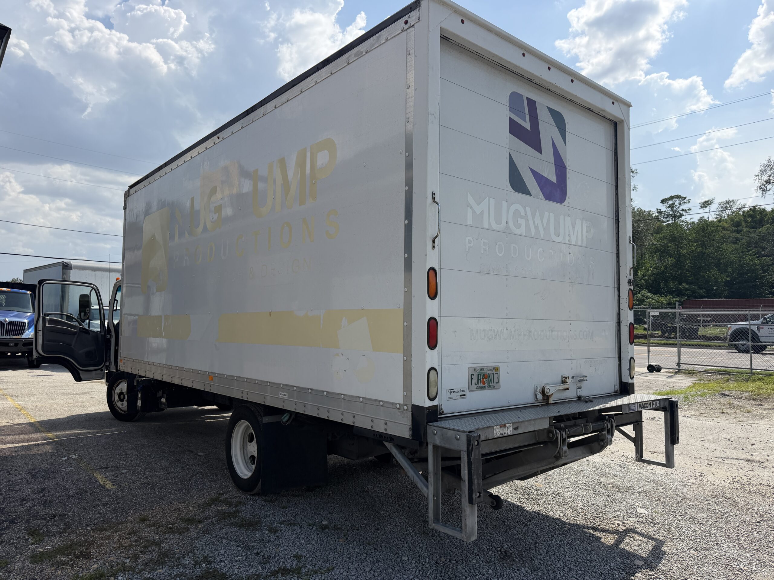 2020 Isuzu NRR 20ft box truck with liftgate and Mugwump Productions logo