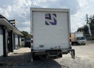 Rear view of a white 2020 Isuzu NRR 20ft. box truck with a liftgate.