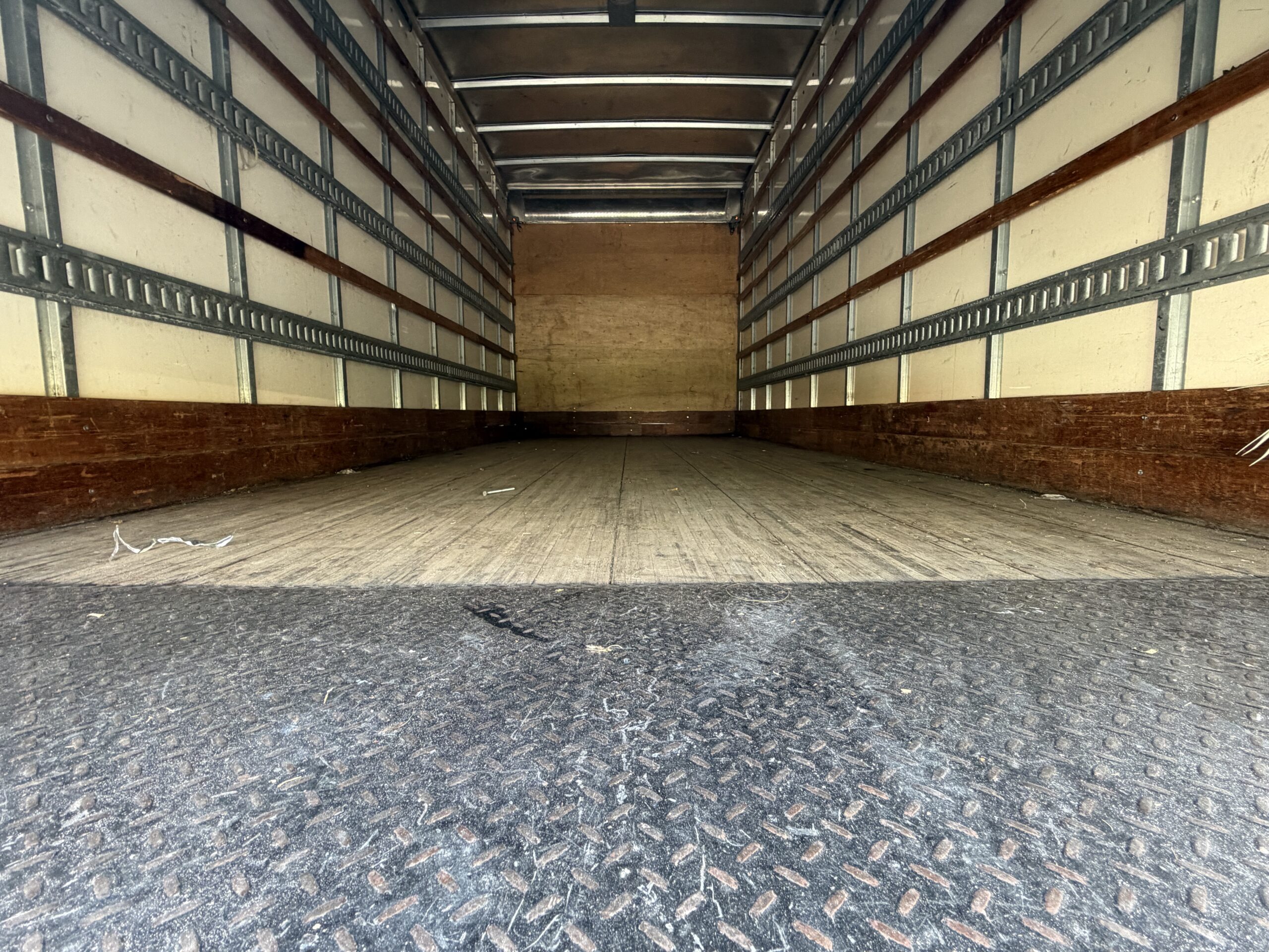 Interior of a 20ft. box truck, showing the cargo area with tie-down rails.