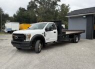 White 2019 Ford F-550 stake body truck with flatbed