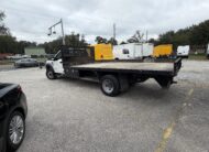 2019 Ford F-550 stake body truck with yellow accents