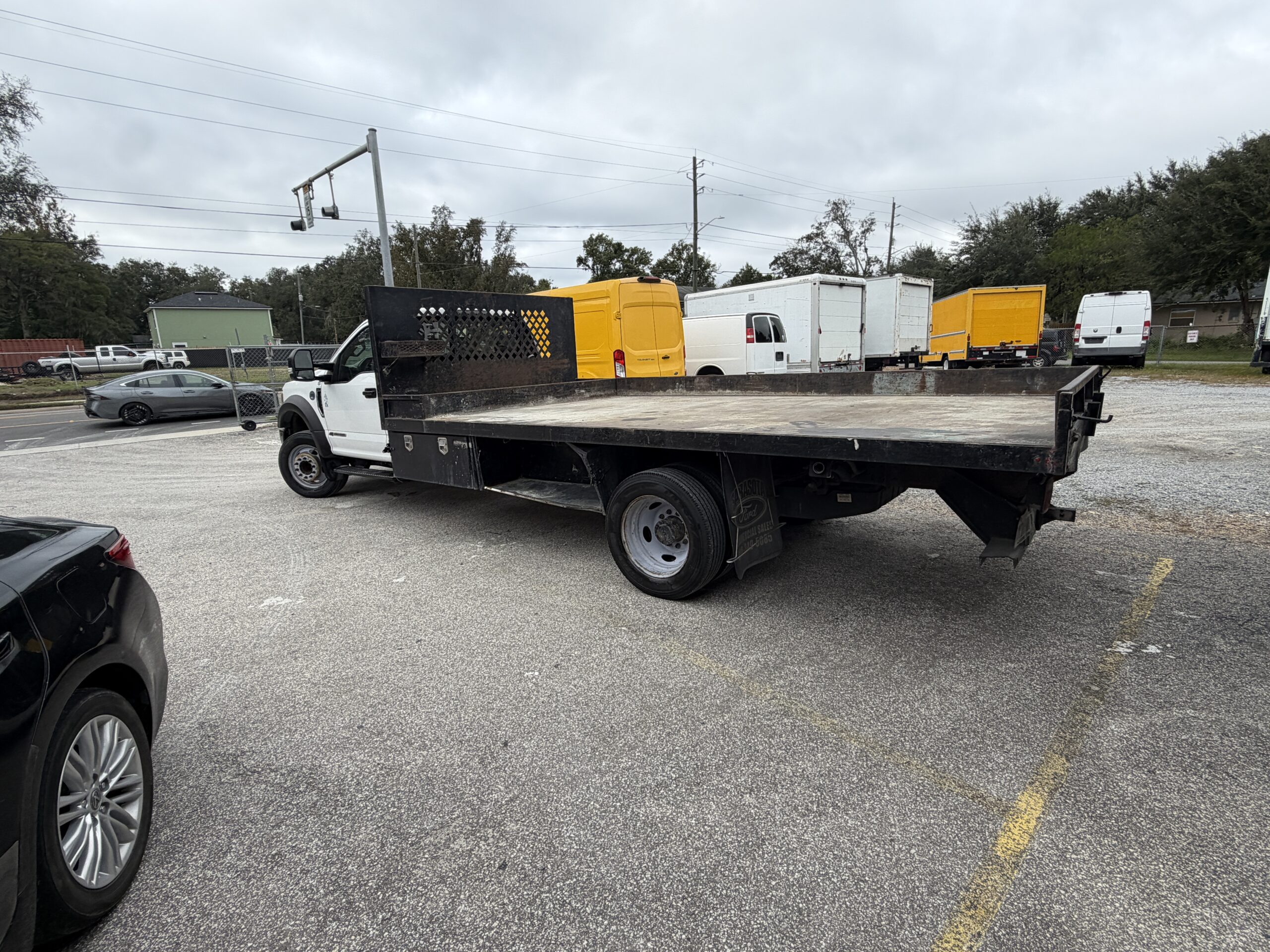 2019 Ford F-550 stake body truck with yellow accents