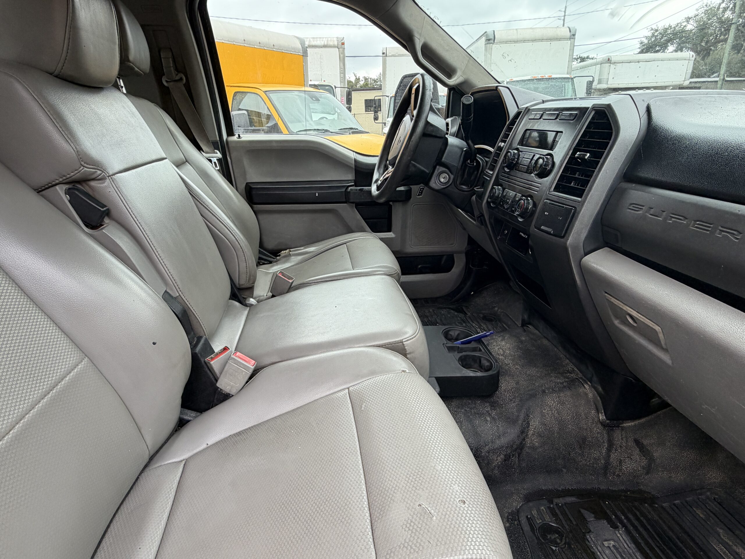 2019 Ford F-550 Super Duty truck interior with gray seats and dashboard.