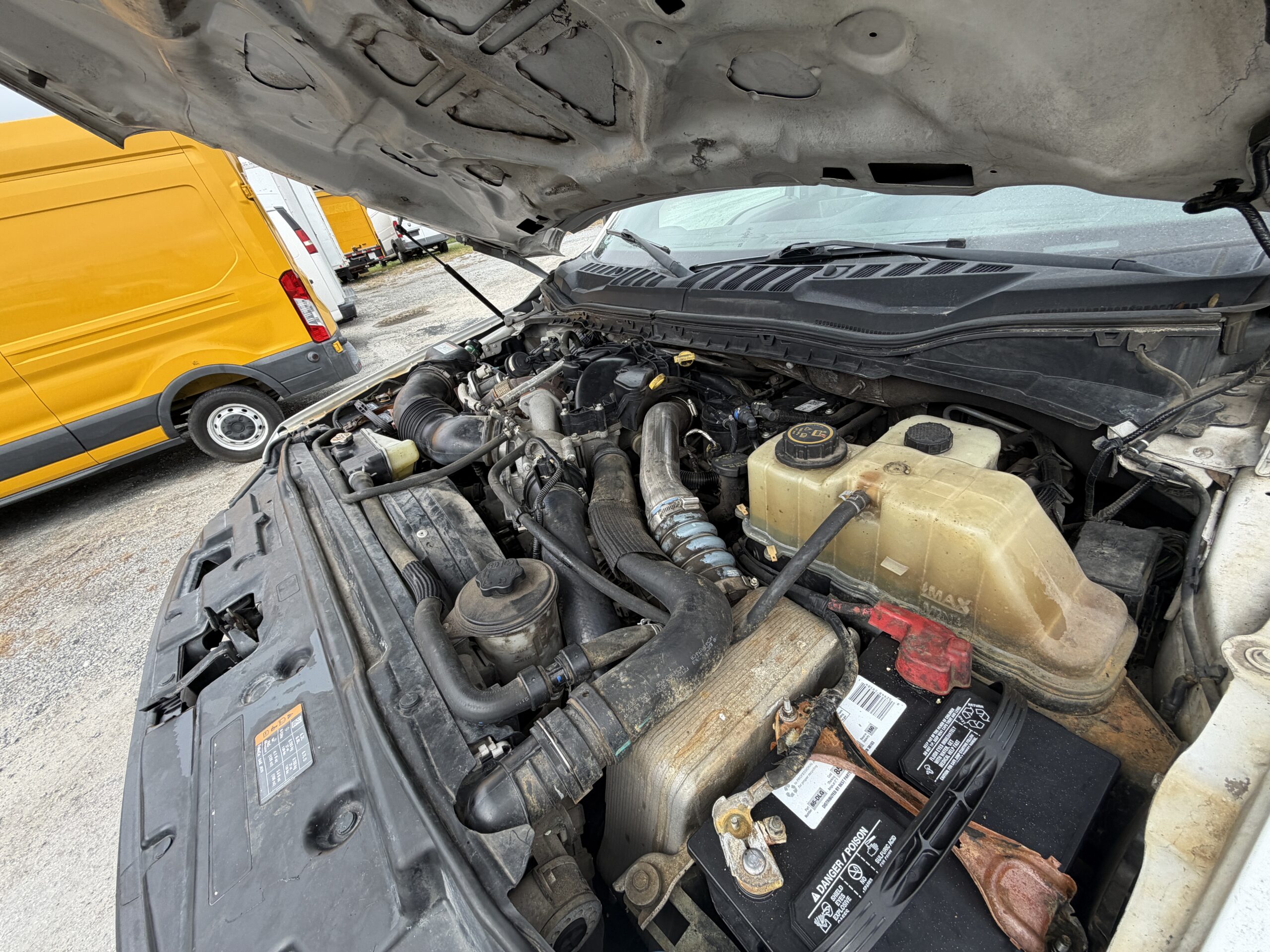 2019 Ford F-550 stake body engine bay with 6.7L PowerStroke diesel