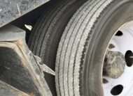Close-up of dual rear tires on a 2019 Ford F-550 stake body truck.