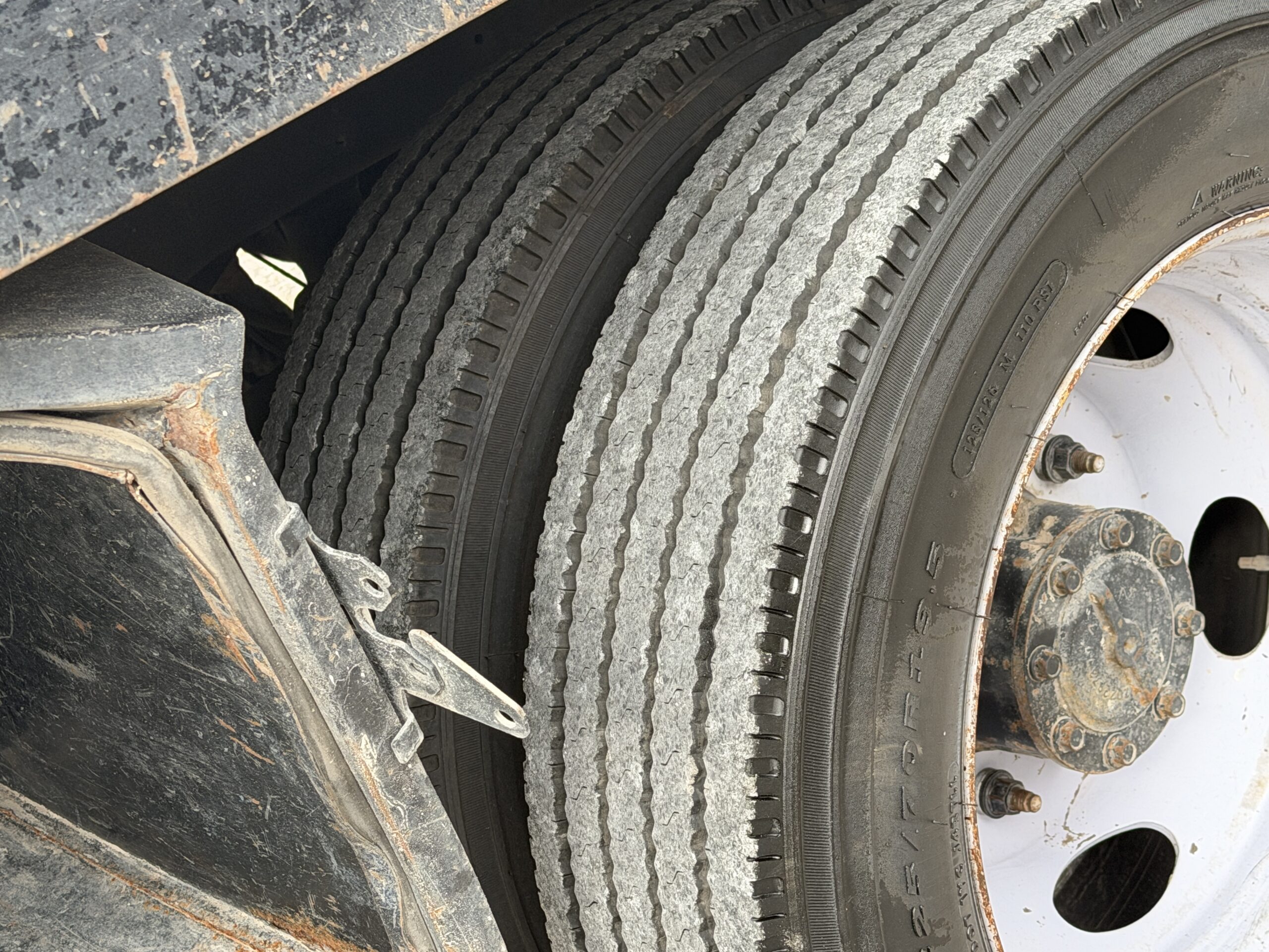 Close-up of dual rear tires on a 2019 Ford F-550 stake body truck.